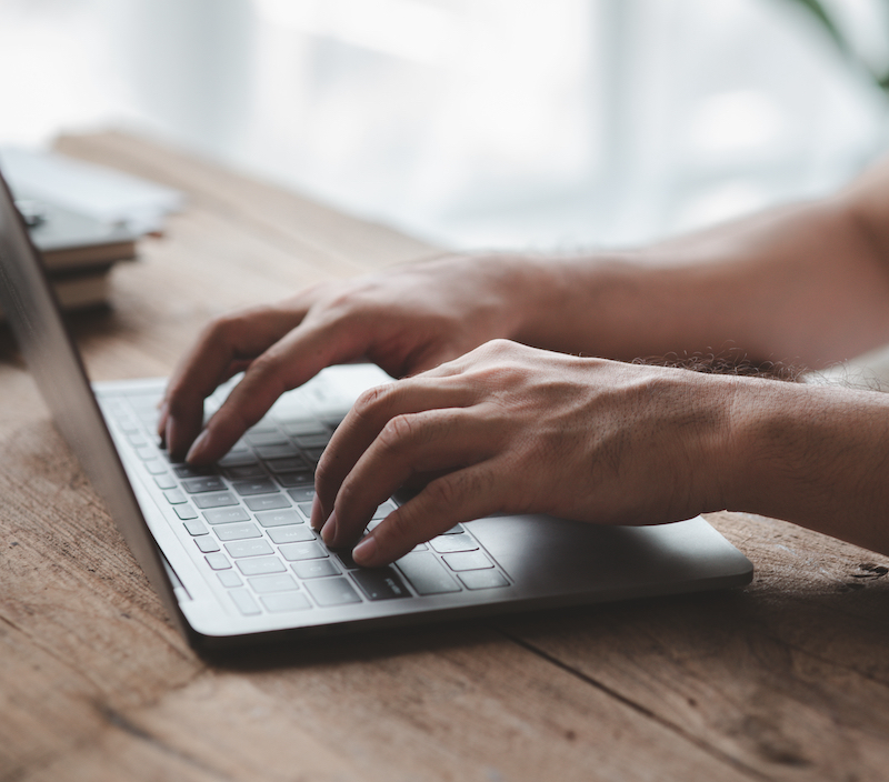 Person Typing On Laptop